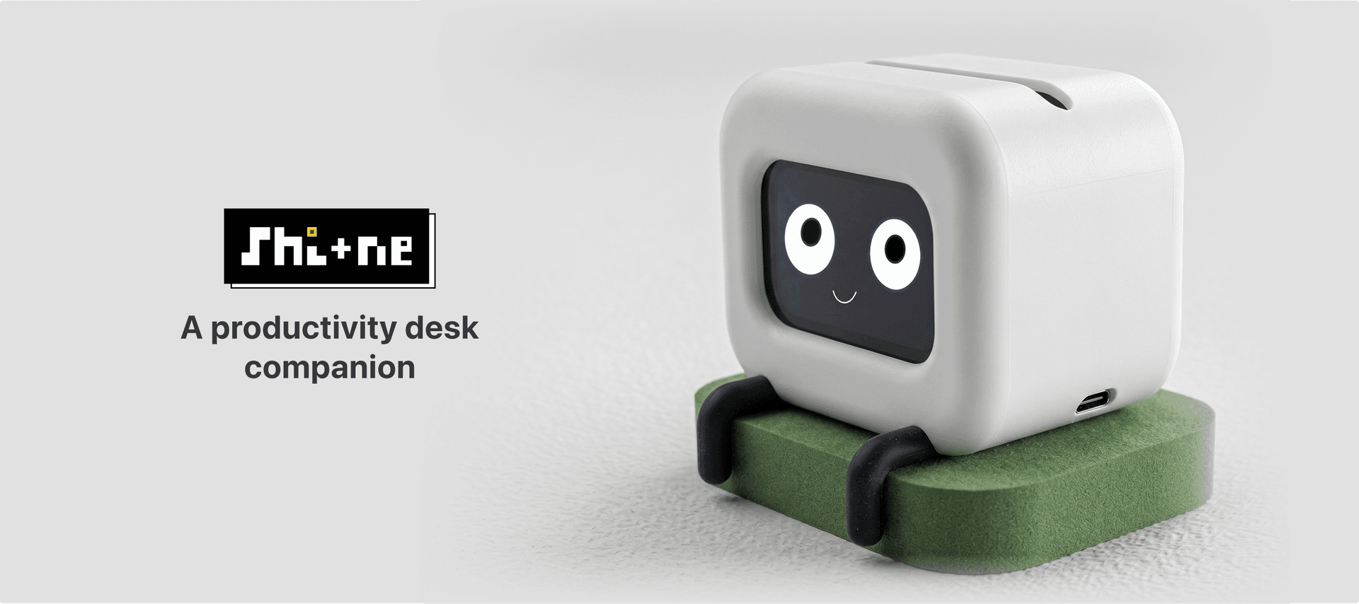 Shi+ne on the desk with pixel logo and the tagline 'A productivity desk companion'