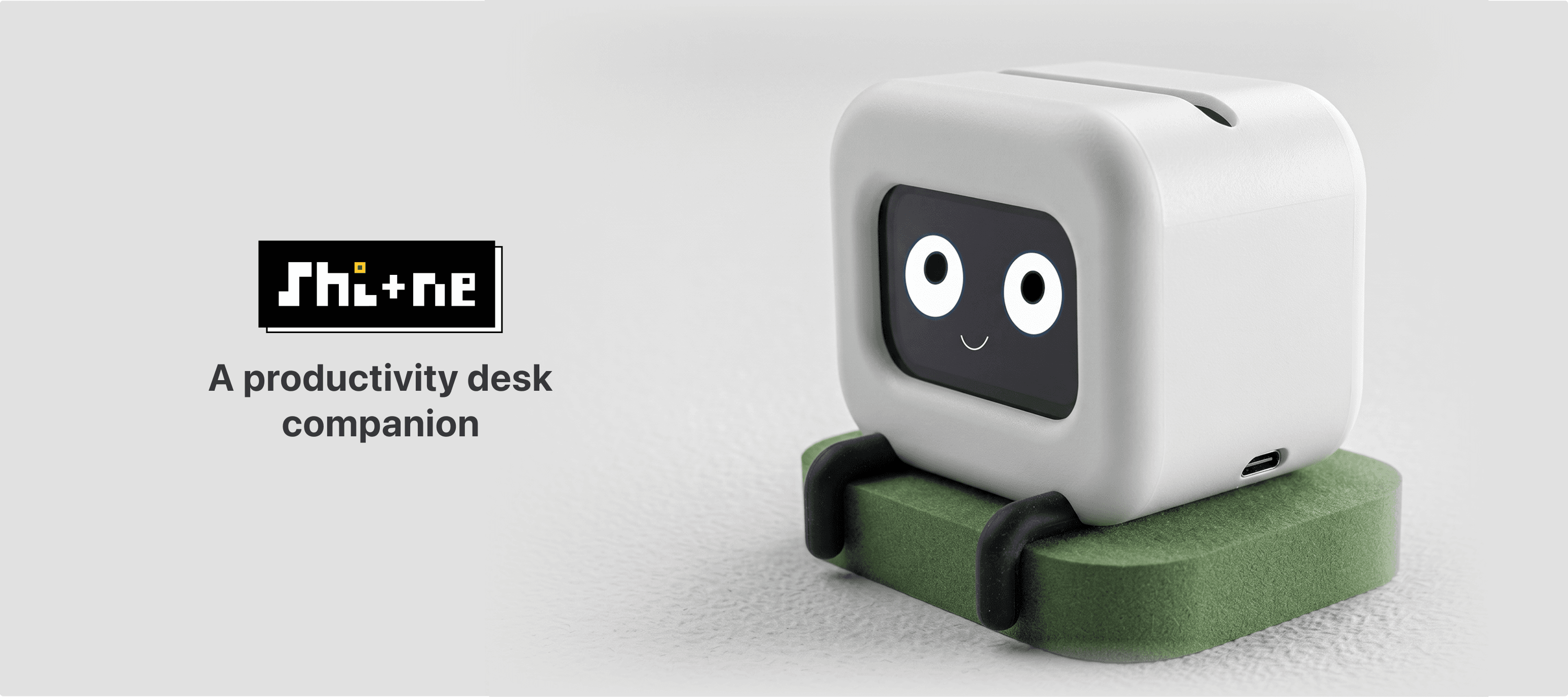Shi+ne on the desk with pixel logo and the tagline 'A productivity desk companion'